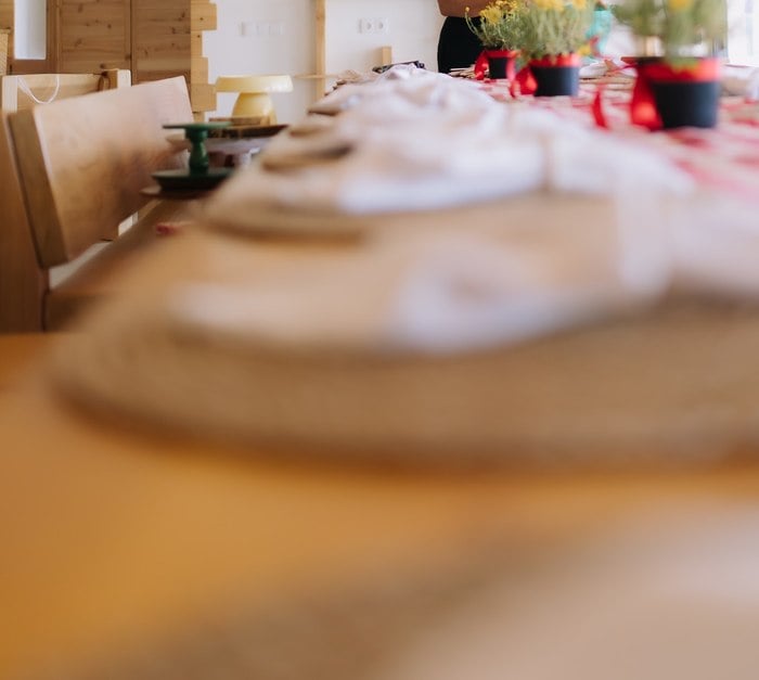 Natural woven place setting with a red gingham table runner