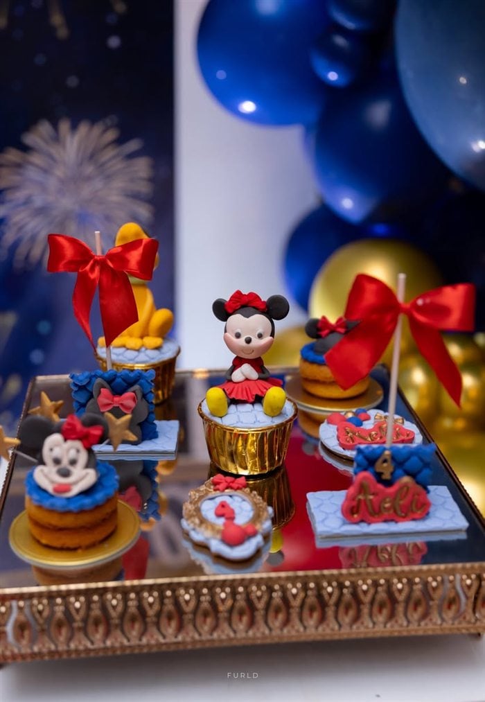 Mickey and Minnie character desserts arranged on an ornate gold tray