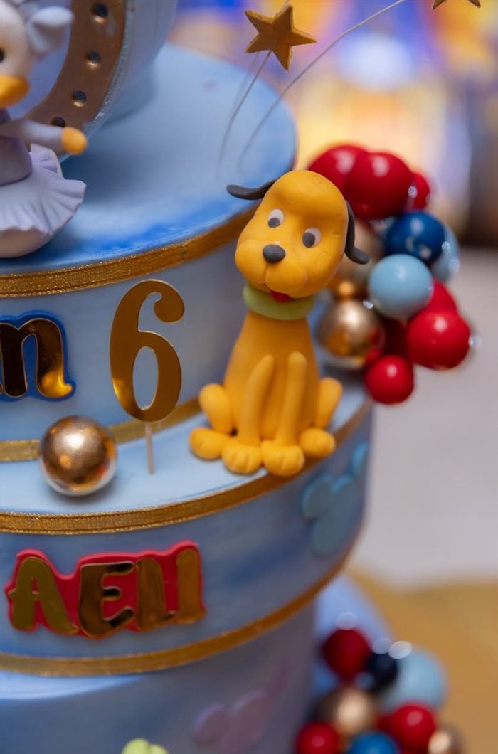 Donald Duck cake detail with blue and gold royal birthday decorations
