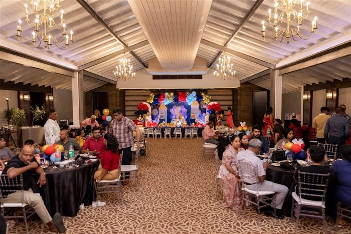 Wide view of the Royal Mickey and Minnie birthday venue with guest tables and balloon decorations