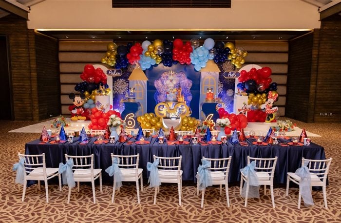 Royal Mickey and Minnie birthday place setting with party hat and bow napkin detail