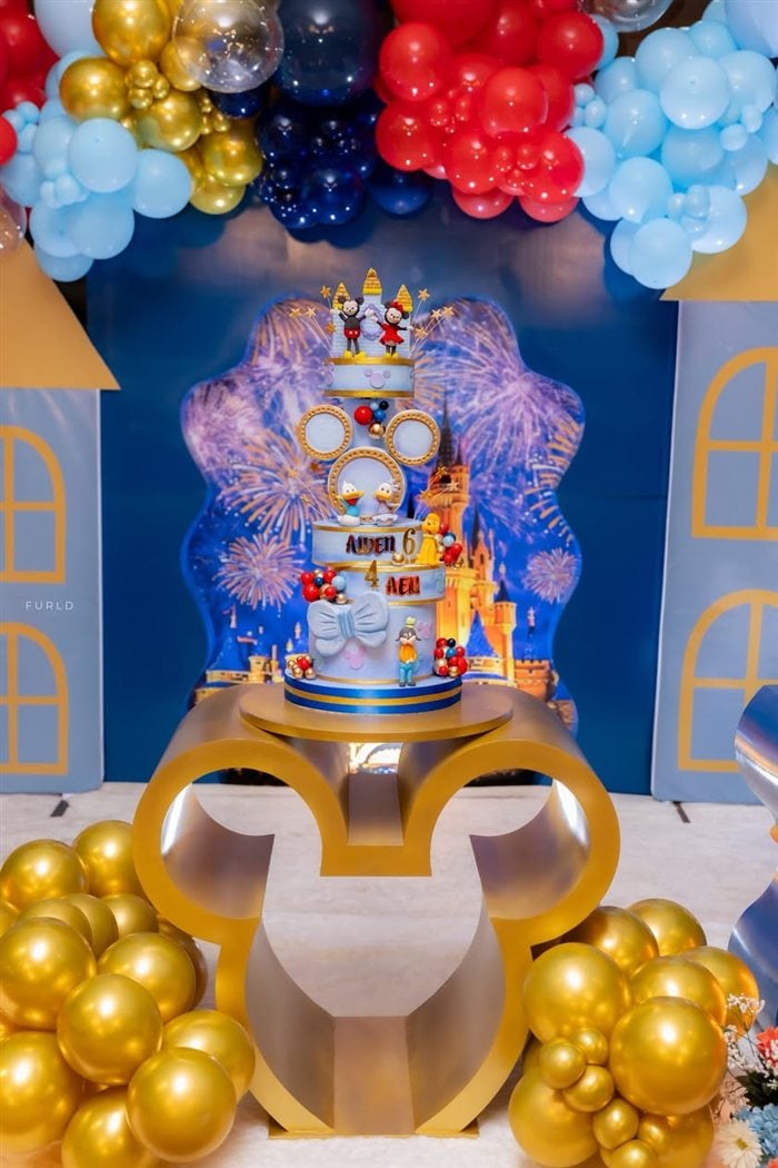 Red Mickey Mouse birthday cake with gold number six topper