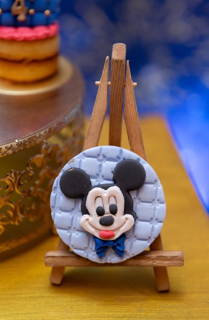 Mickey Mouse cookie displayed on a miniature easel at a royal birthday party