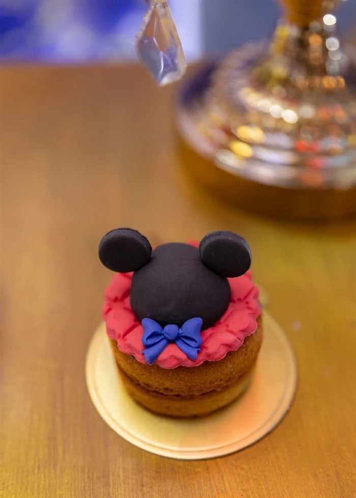 Mickey Mouse mini dessert with red bow and gold presentation plate
