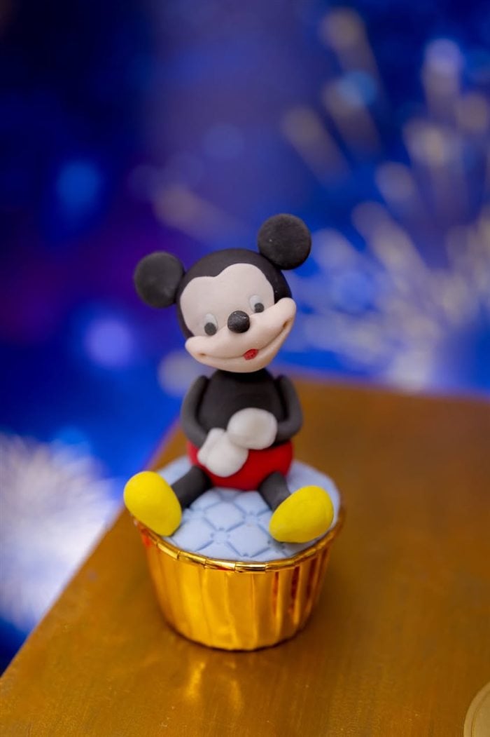 Mickey Mouse party hat and red napkin at a royal birthday table