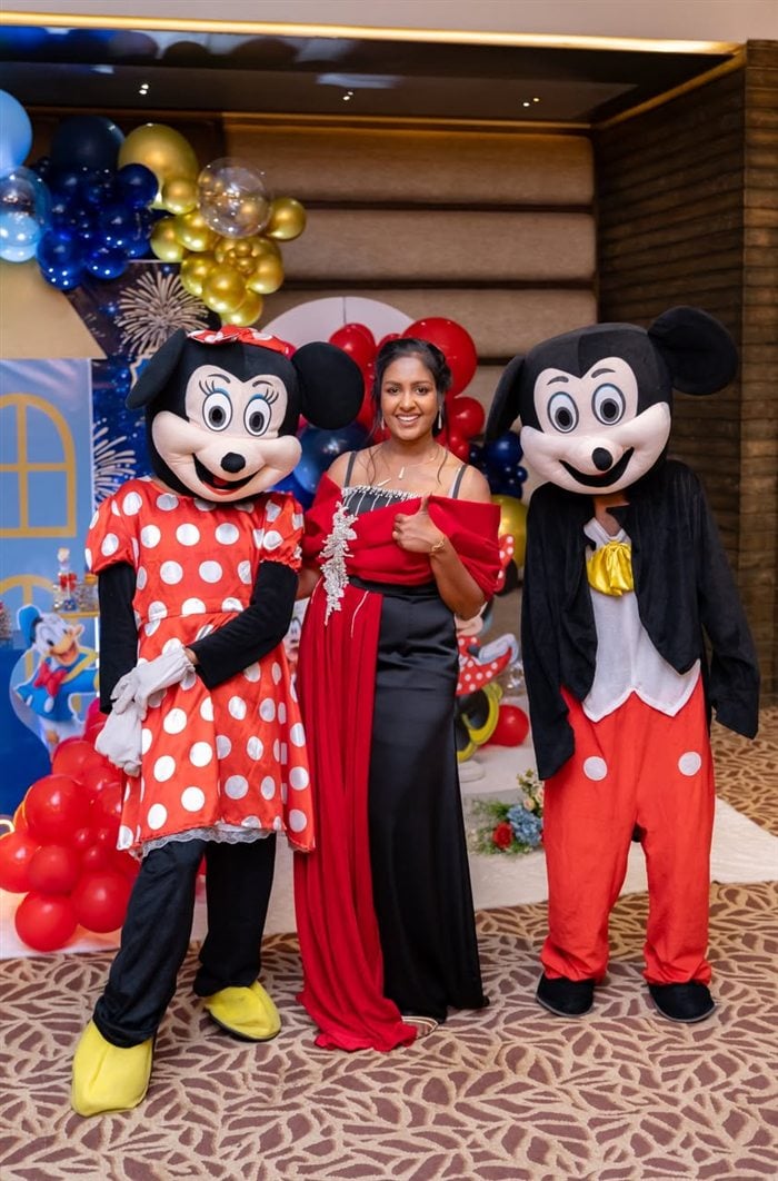 Miniature Mickey and Minnie desserts with red bows and royal blue details