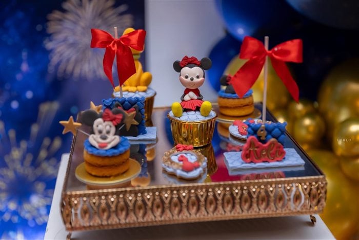 Minnie Mouse desserts with red bows displayed on a mirrored tray