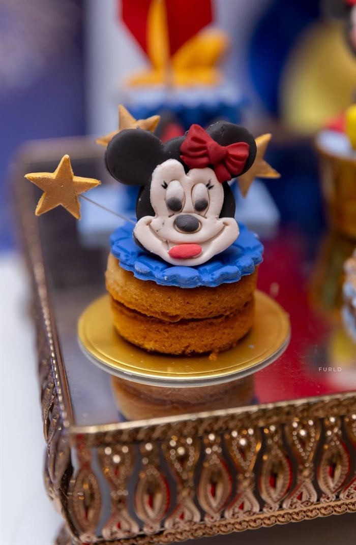 Minnie Mouse themed mini dessert with a red bow and blue frosting