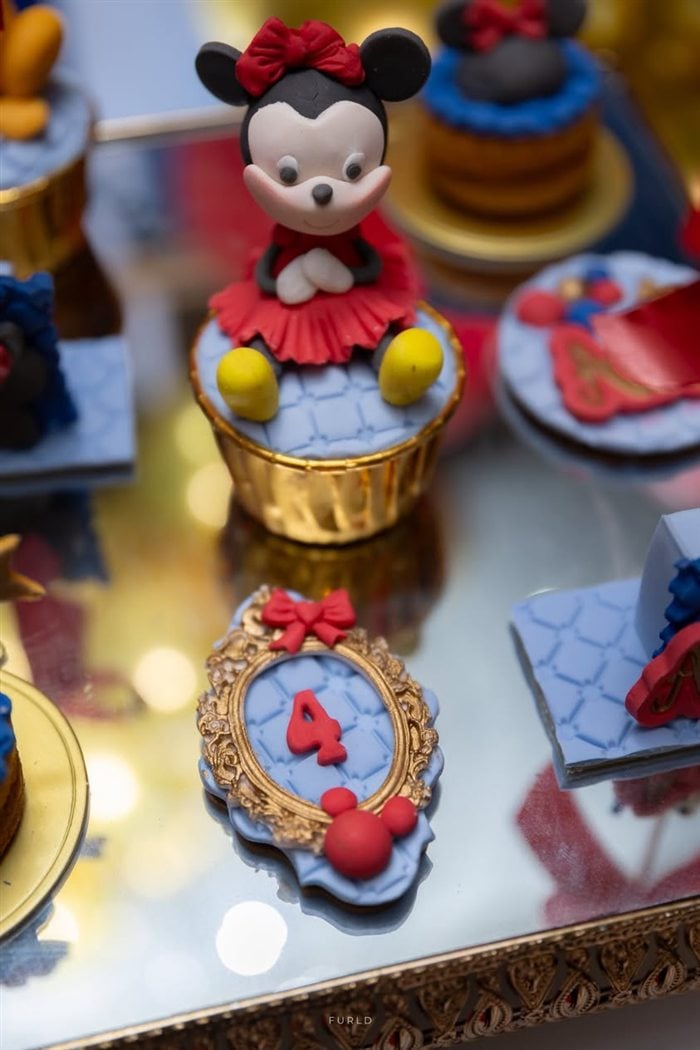 Minnie Mouse number four birthday cake with red gold and blue balloons