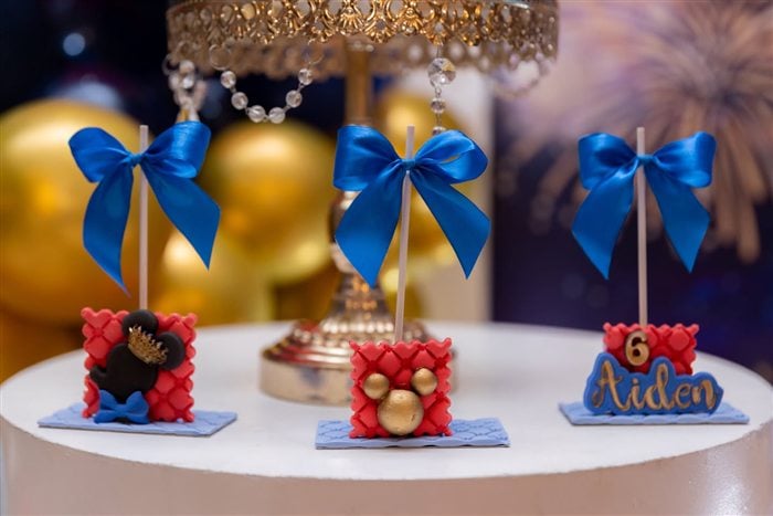 Royal Mickey and Minnie cake pops with blue bows and personalized Aiden detail