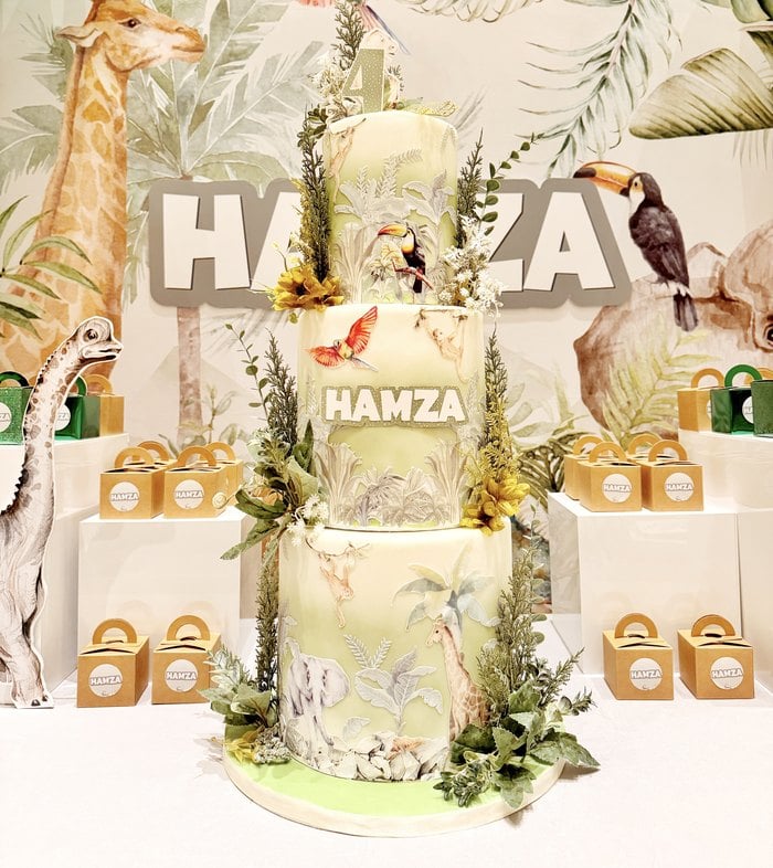 Three tier cake with personalized safari favor boxes
