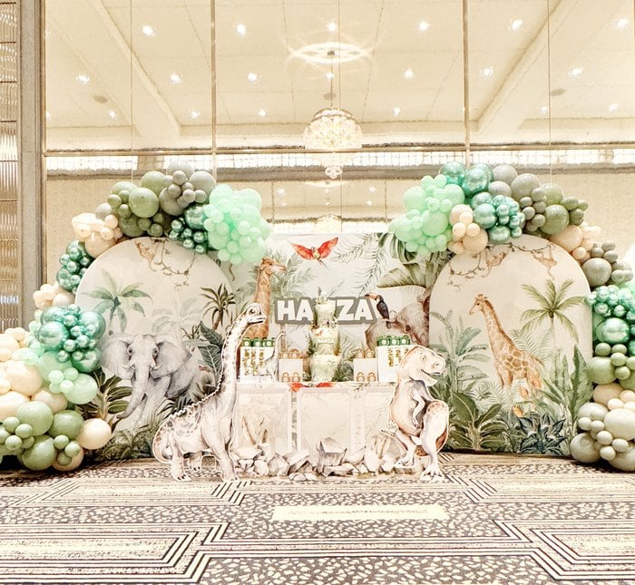 Full dinosaur and safari balloon backdrop with dessert table