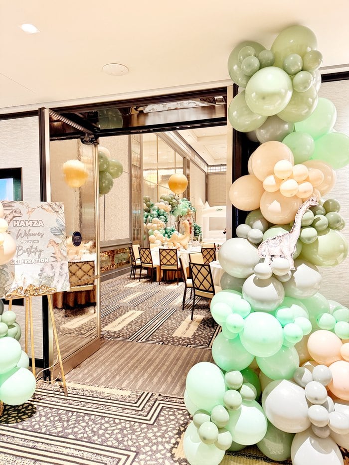 Jurassic safari entrance decorated with organic balloons and animal accents
