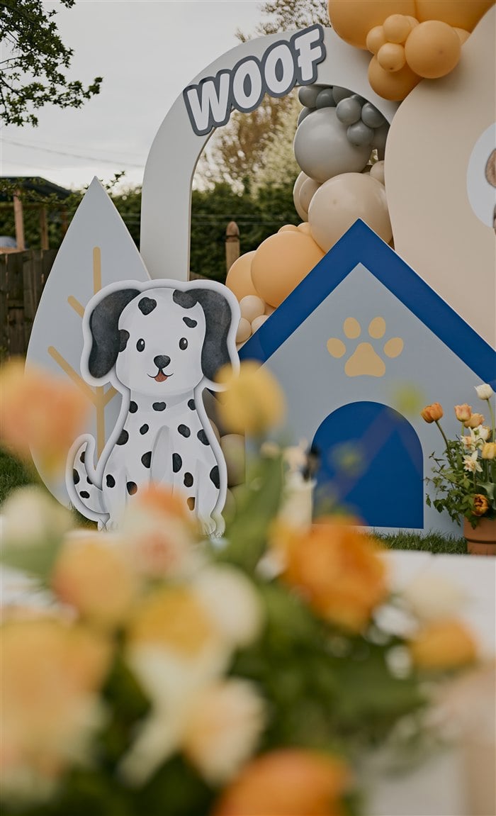 Dalmatian cutout and blue dog house on the puppy party backdrop