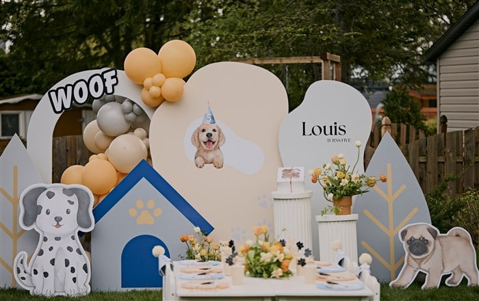 Puppy birthday backdrop with dog cutouts blue dog house and peach balloons