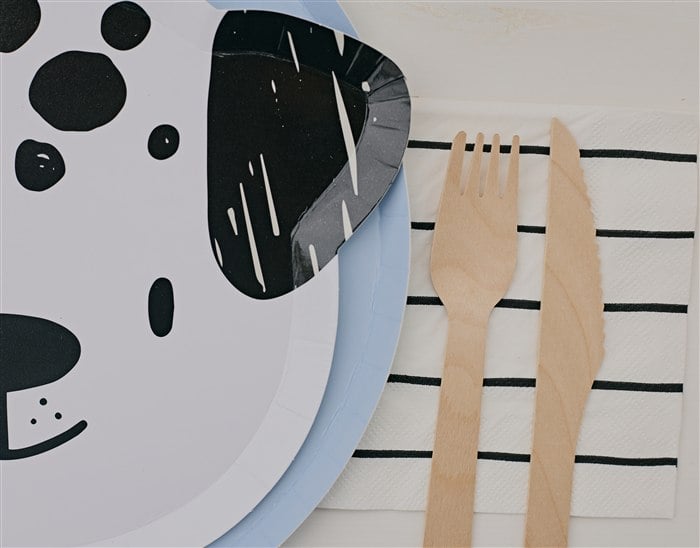Dog face plate wooden flatware and striped napkin flat lay