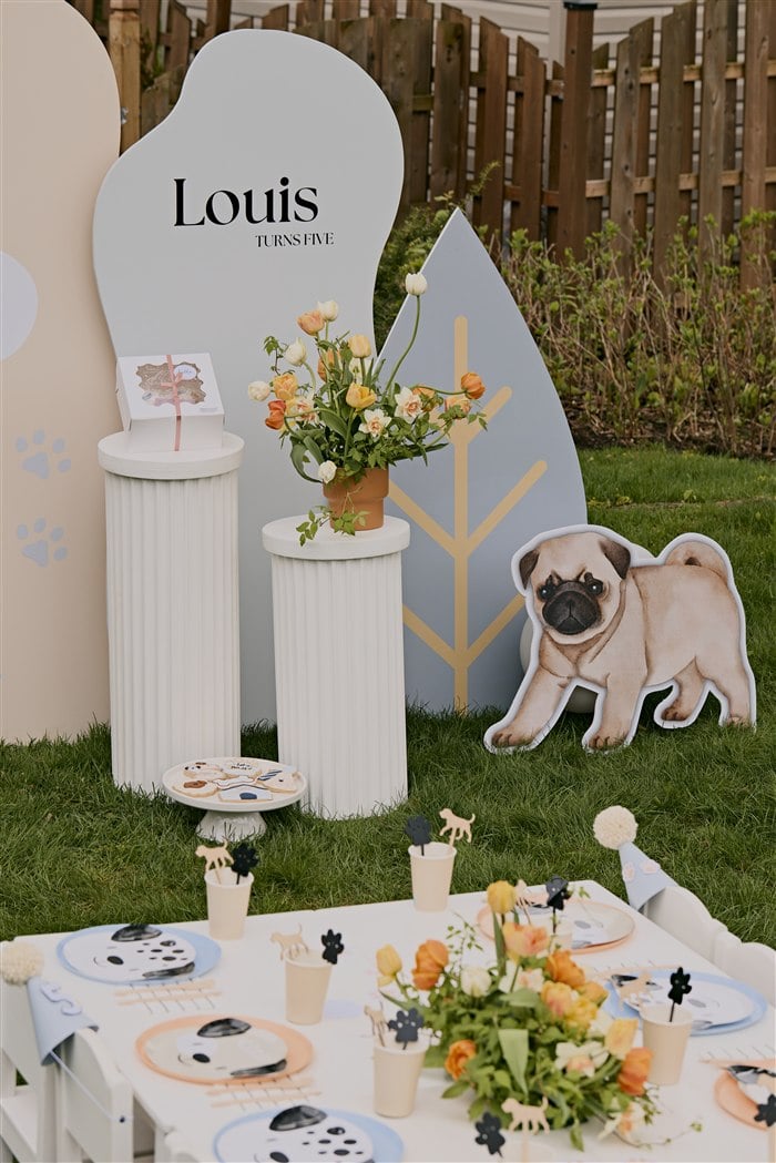 Portrait view of the full puppy party backdrop and table