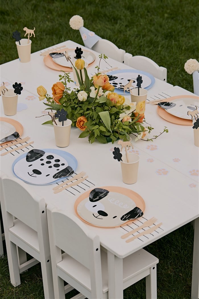 Long children's table with puppy plates flowers and paw stirrers