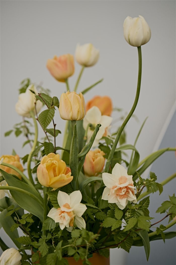 Orange tulips roses and greenery at a puppy birthday party