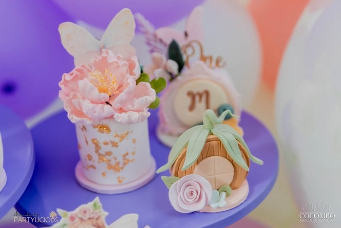 Close-up of fairy themed desserts in pink and lavender