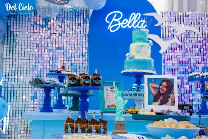 Taylor Swift 1989 cake and dessert table with blue shimmer backdrop