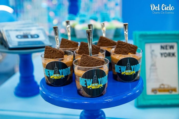 New York themed chocolate dessert cups on a blue cake stand