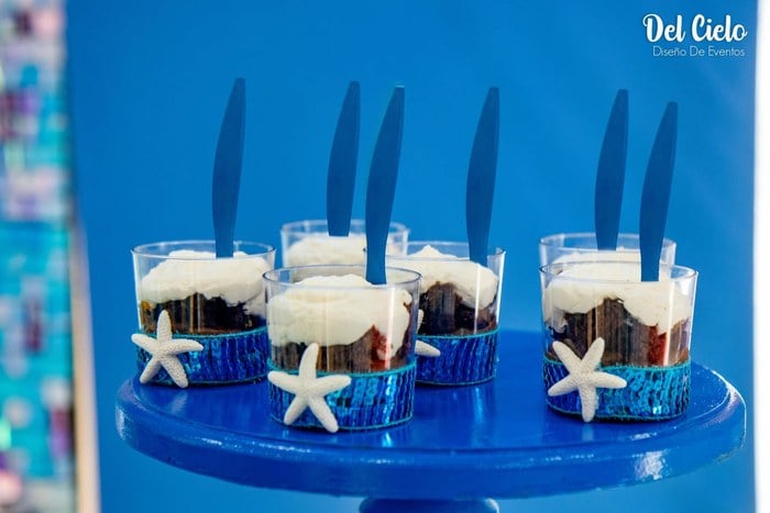 Ocean-blue dessert cups with starfish decorations